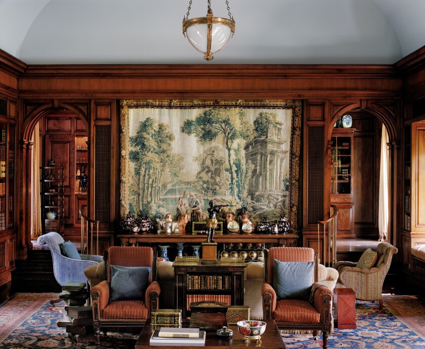 The Georgian-style traditional home features detailed crown moldings, coved ceilings and hand-carved fireplaces.