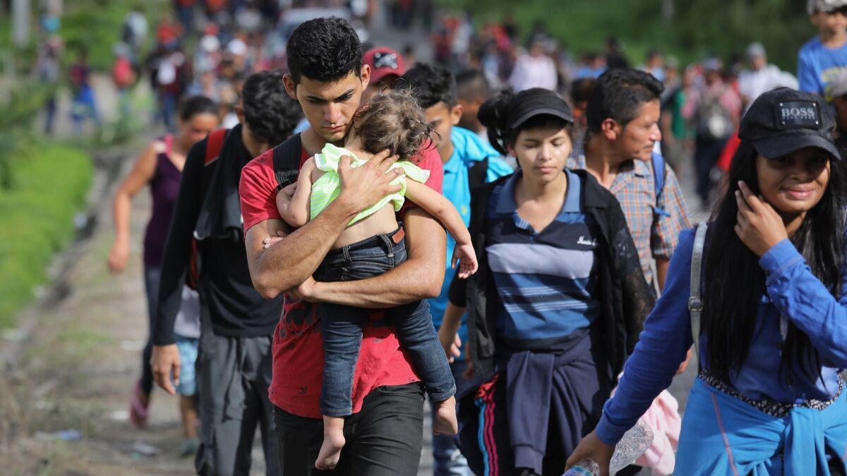 A caravan of more than 1,500 Honduran migrants moves north after crossing the border from Honduras into Guatemala on Monday in Esquipulas, Guatemala.