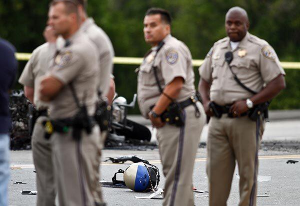 California Highway Patrol officers gather at the scene of the crash in Redlands that killed Officer Tom Coleman. On Wednesday, another officer was badly hurt in an accident in Los Angeles. See full story