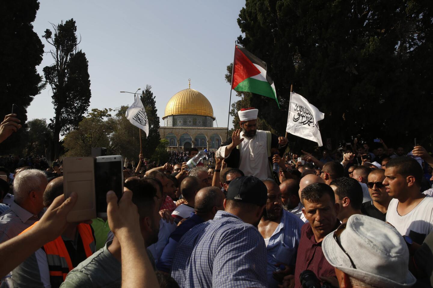 Palestinians are seen inside the Al Aqsa Mosque compound in Jerusalem's Old City Thursday, July 27.