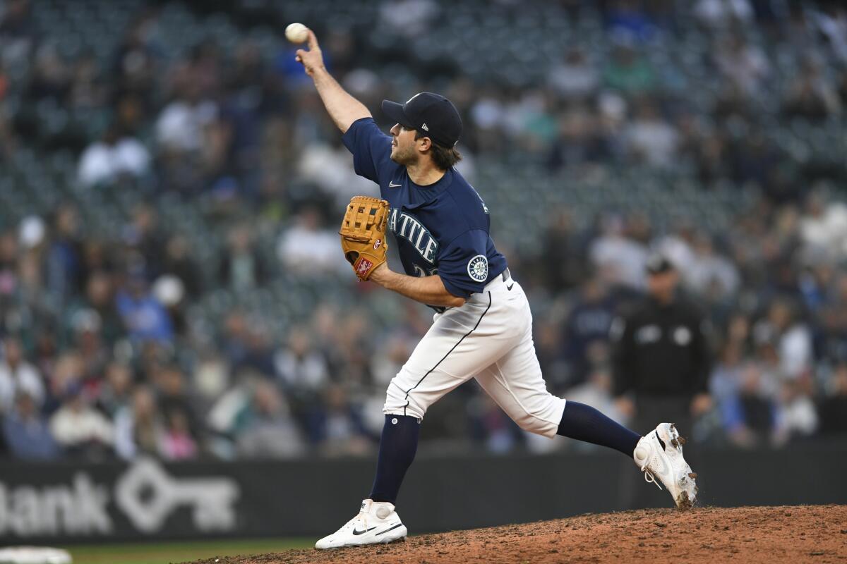 Seattle Mariners catcher Luis Torrens pitches against the Detroit Tigers during the 10th inning of the first game of a baseball doubleheader, Tuesday, Oct. 4, 2022, in Seattle. (AP Photo/Caean Couto)