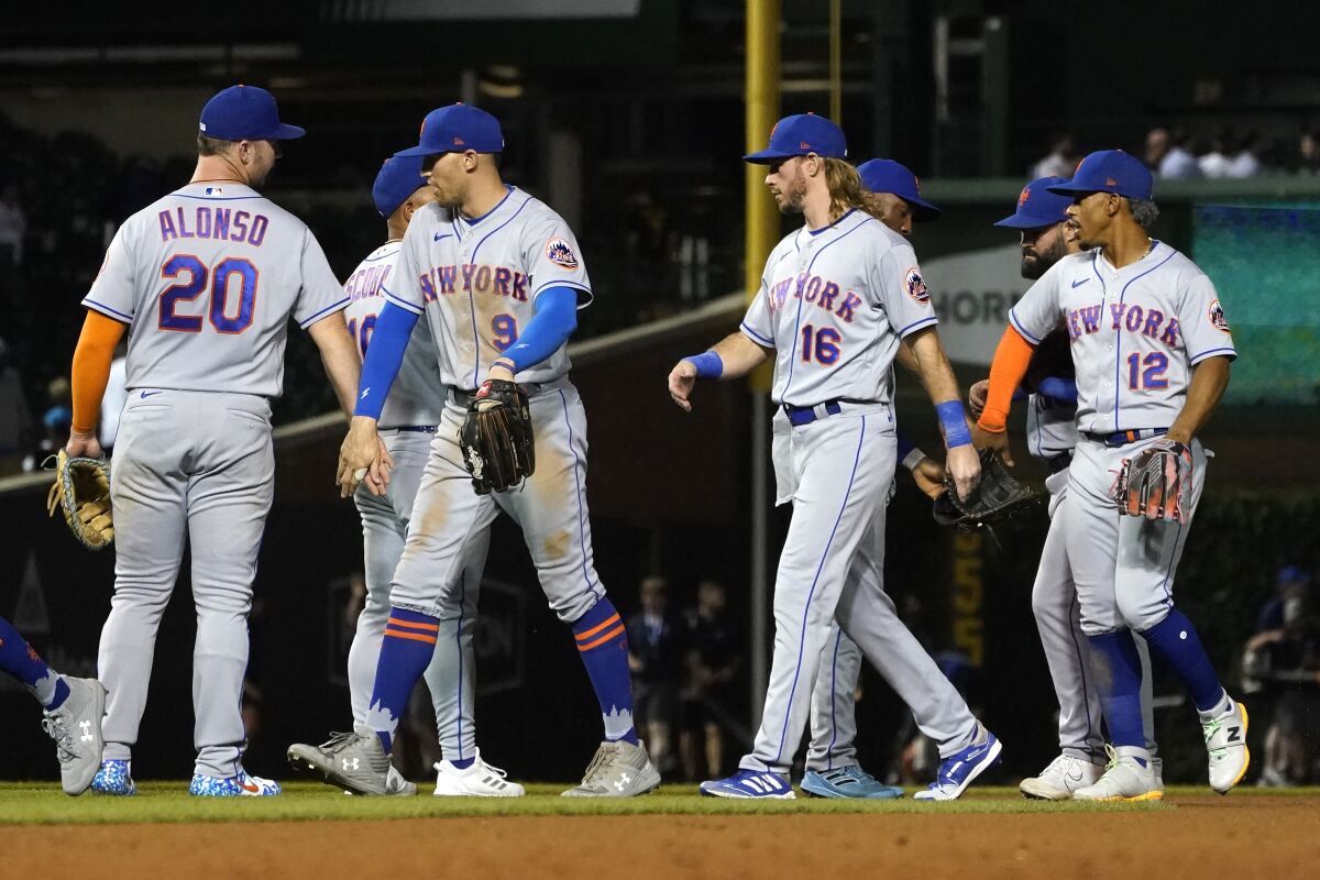 The New York Mets celebrate the team's 8-0 shutout of the Chicago Cubs in a baseball game Thursday, July 14, 2022, in Chicago. (AP Photo/Charles Rex Arbogast)