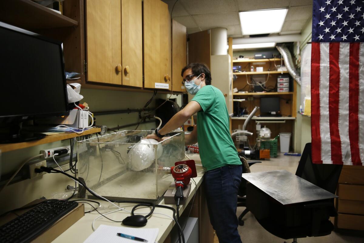 Albert Nazeeri, a Caltech student, demonstrates his system for disinfecting N95 respirators