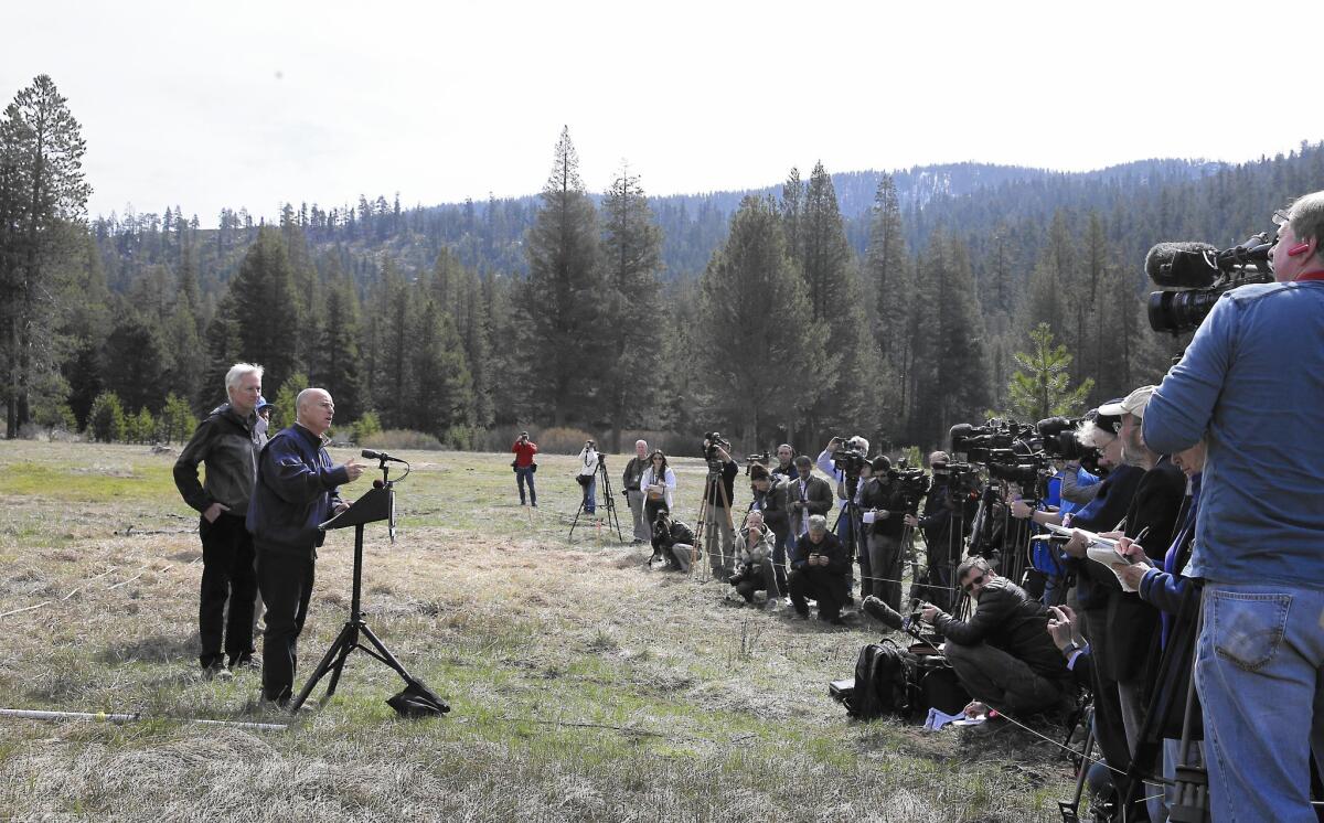 Gov. Jerry Brown talks to reporters in Echo Summit, Calif., about his new executive order mandating cities and towns to cut water usage by 25%.