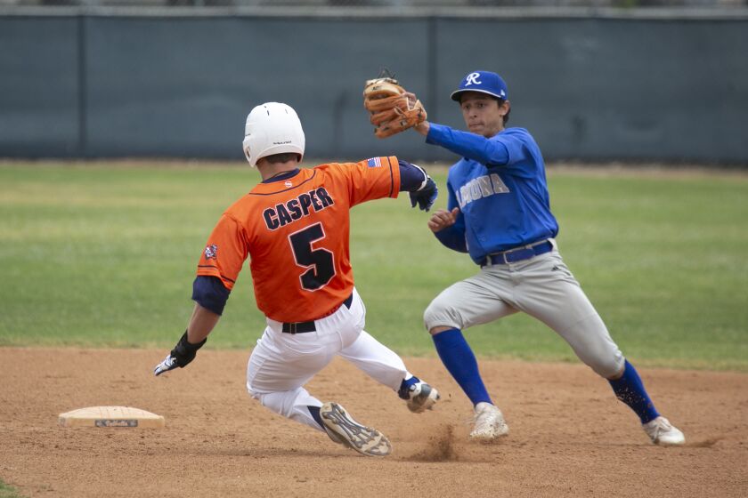 Valhalla's #5 Kyle Casper is tagged out at second base by Ramona's #3 E.J. Edelman during the game against Ramona High School, during the Lions Baseball Tourney played at Valhalla High School.