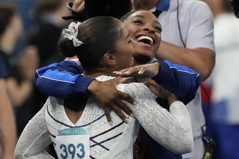 Jordan Chiles (393), of the United States, reacts to seeing she won the bronze medal.