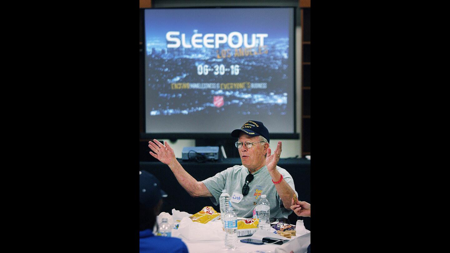 Randy Slaughter, of Glendale, tells a life story at the dinner table at the Rose Bowl for the Salvation Army's Sleepout Los Angeles on Thursday, June 30, 2016. The "sleepout" is a fundraiser providing business leaders and community members an opportunity to personally experience homelessness.
