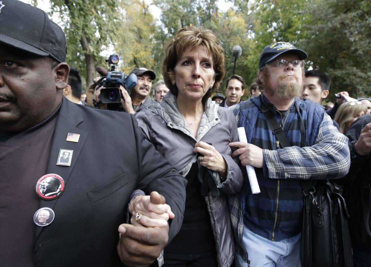 UC Davis Chancellor Linda Katehi is escorted from the stage after speaking about the pepper-spraying incident on campus in 2011.