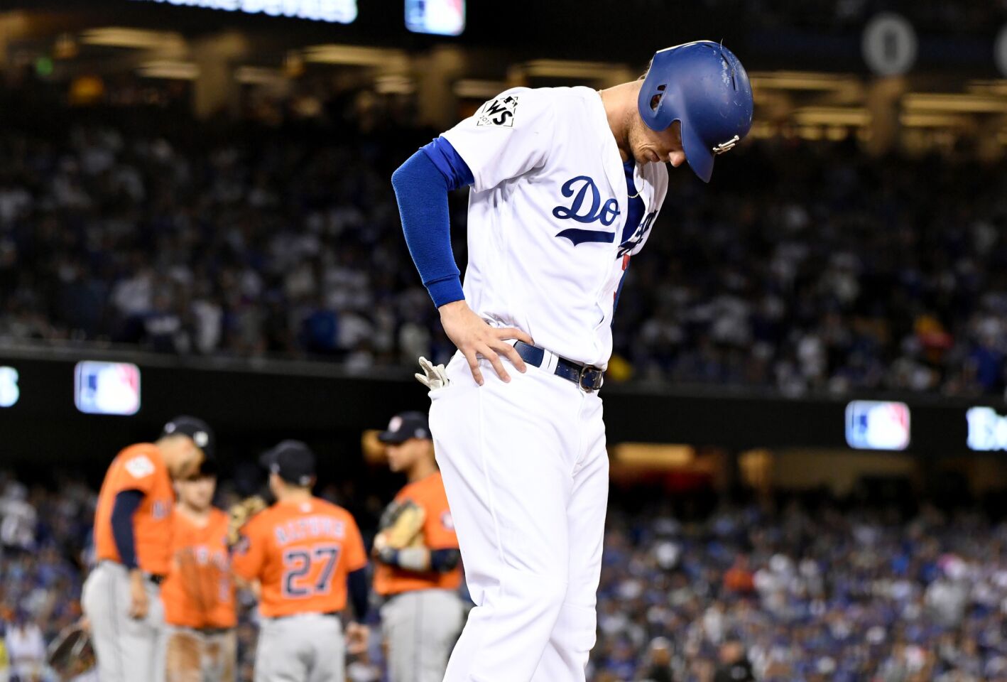 Cody Bellinger looks down while standing on first base after a force-out in the fifth inning.