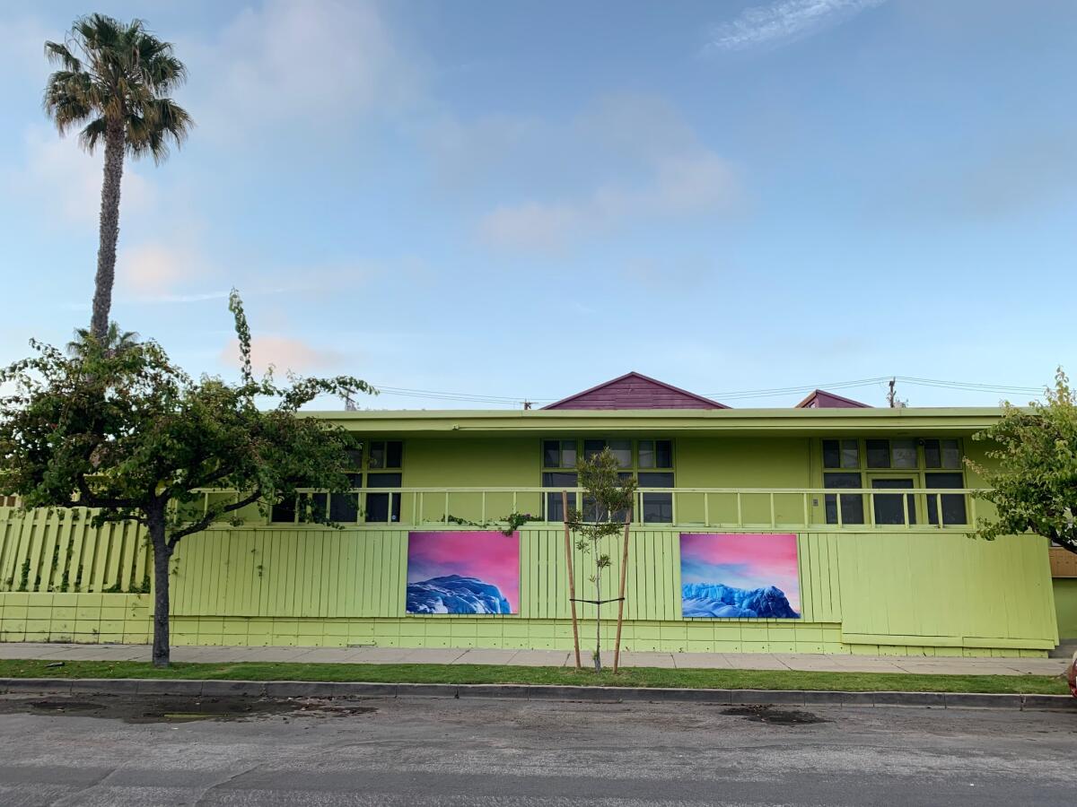 An installation view of outdoor paintings by Argentine artist Luciana Abait, on view as part of the outdoor exhibition "We Are Here / Here We Are."