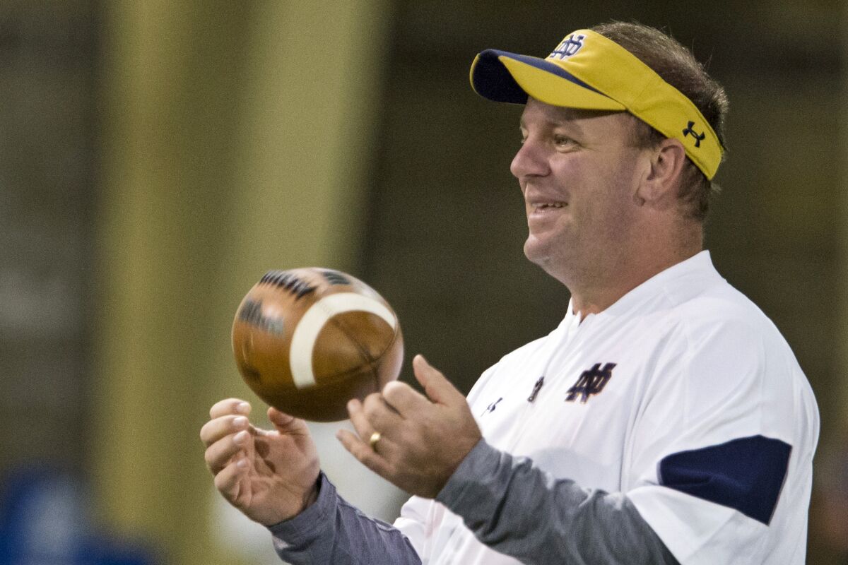 FILE - Notre Dame defensive coordinator Mike Elko runs drills during NCAA college football practice, on March 22, 2017, in South Bend, Ind. Duke announced Friday night, Dec. 10, 2021, that they hired Elko as its new head football coach. Elko, 44, has spent the past four seasons as defensive coordinator and safeties coach at Texas A&M. Before that, had also worked at Notre Dame, Wake Forest and Bowling Green in the past decade. (Becky Malewitz/South Bend Tribune via AP, File)