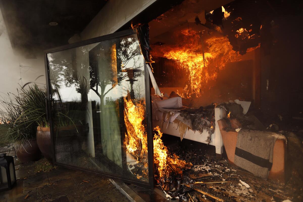 The bedroom of a home is engulfed in flames from the Skirball fire along Linda Flora Drive in Bel-Air.