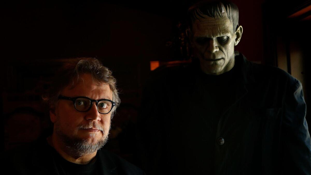 Guillermo del Toro is photographed next to a creature of Frankenstein, on display inside his monster themed Bleak House in Westlake Village on June 13, 2016.