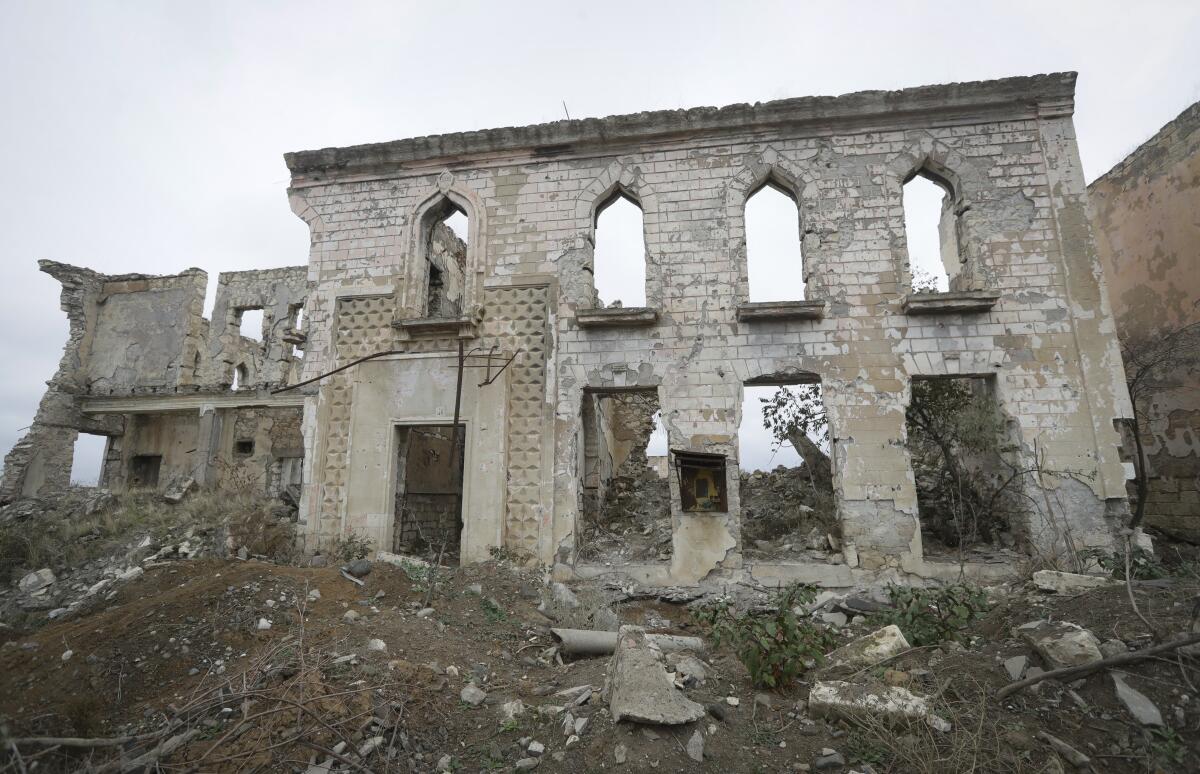 Ruined buildings in Aghdam, which Armenian-backed forces have handed back to Azerbaijan