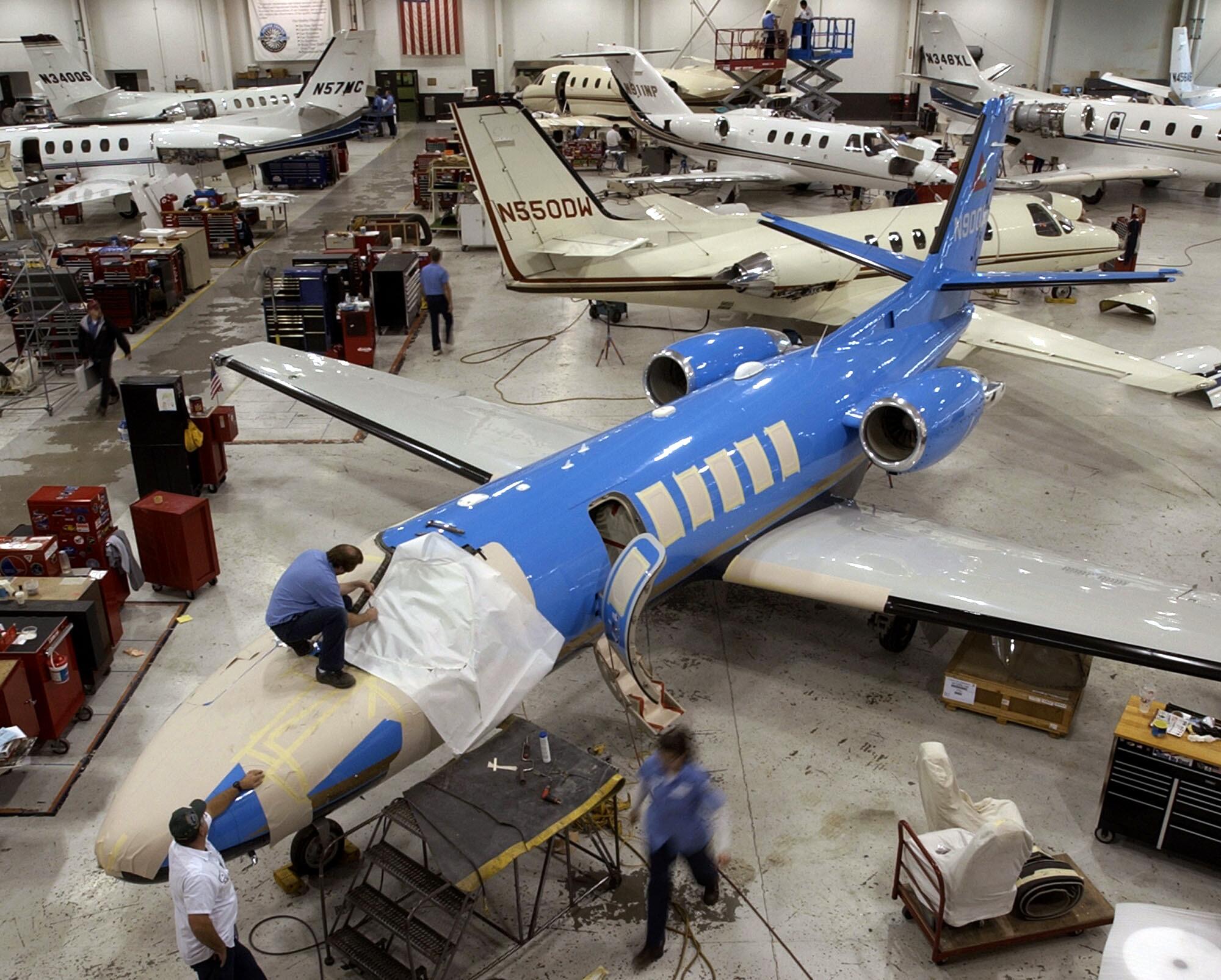 Workers service Cessna Citation business jets at Cessna's service center in Wichita, Kansas.