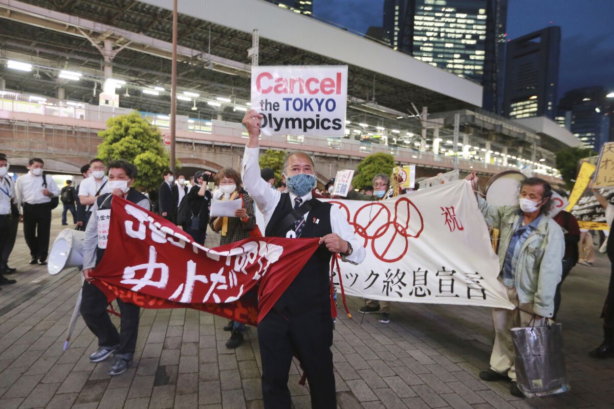 FILE - In this May 17, 2021, file photo, demonstrators protest against the Tokyo 2020 Olympics in Tokyo. The IOC and Tokyo Olympic organizers start three days of virtual meetings Wednesday, May 19, 2021 and will run into some of the strongest medical-community opposition so far with the games set to open in just over eight weeks. (AP Photo/Koji Sasahara, File)