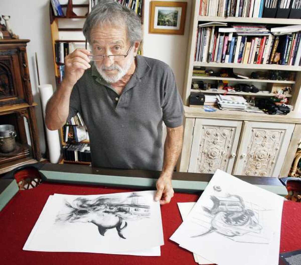 Joe Alves, in his Woodland Hills home showing his sketches of the big shark that eventually turned into Jaws. Alves designed the shark in Jaws and will be sharing stories of the work that went into the making of the movie at the Alex Theatre on July 28.
