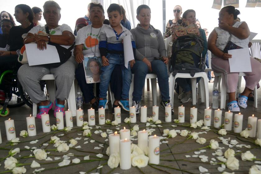 Relatives of missing people and other people affected by the Colombian conflict attend the International Day of the Disappeared in Medellin, Antioquia Department, Colombia, on August 30, 2016.