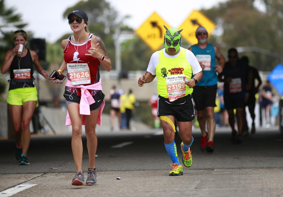 Sierra Hall, left, of Huntington Beach and J.A.V.D. Toro of Calexico run in the Rock 'n' Marathon.