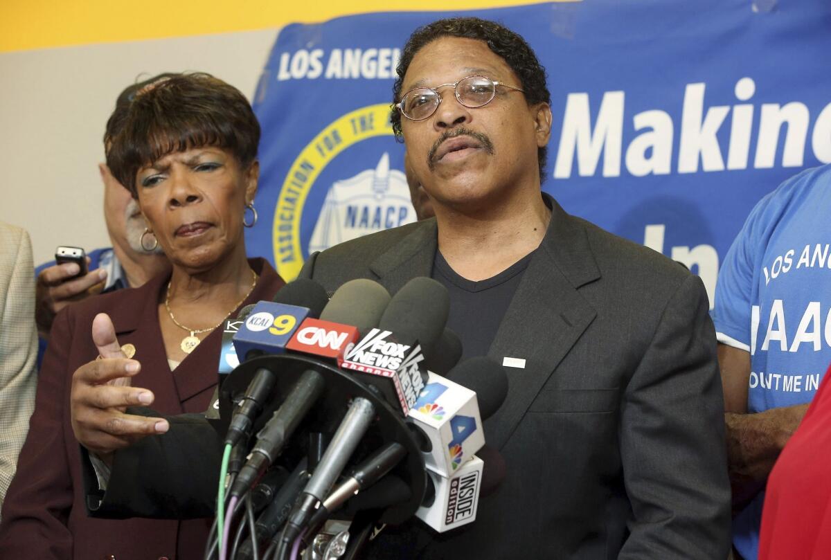 Leon Jenkins, center, president of the Los Angeles chapter of the NAACP, announces that Los Angeles Clippers owner Donald Sterling will not be receiving a lifetime achievement award from the organization, at a news conference in Culver City, Monday, April 28, 2014.