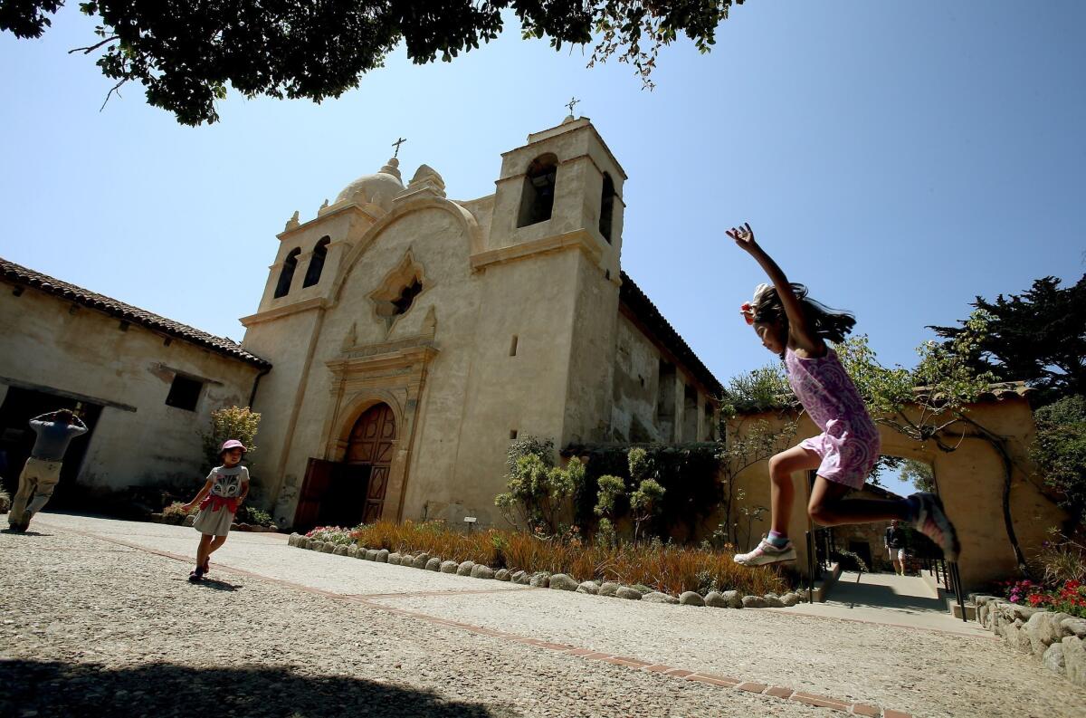 Children play in the courtyard outside the Carmel Mission. The mission was the headquarters of the Alta California missions headed by Father Junípero Serra from 1770 until his death in 1784.