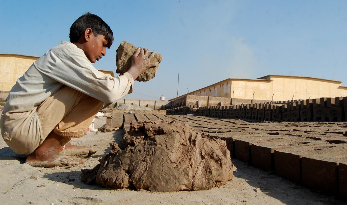 Shahzad, 12, makes bricks at the kiln. He dreams of going to school instead.