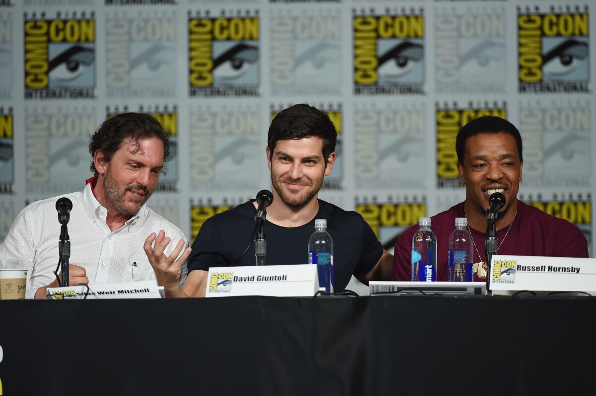 Actors Silas Weir Mitchell, left, David Giuntoli and Russell Hornsby speak onstage at the "Grimm" season 5 panel during Comic-Con International 2015.