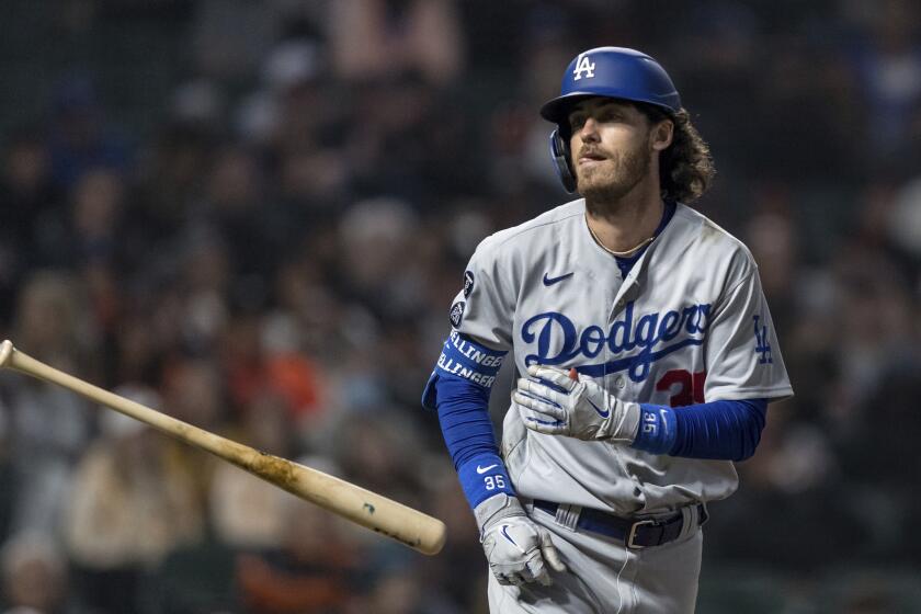 Los Angeles Dodgers' Cody Bellinger tosses the bat after he is walked in the ninth inning.