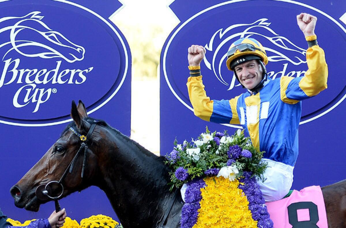 Jockey Richard Hughes celebrates atop Chriselliam after winning the Breeders' Cup Juvenile Fillies Turf on Friday at Santa Anita Park.