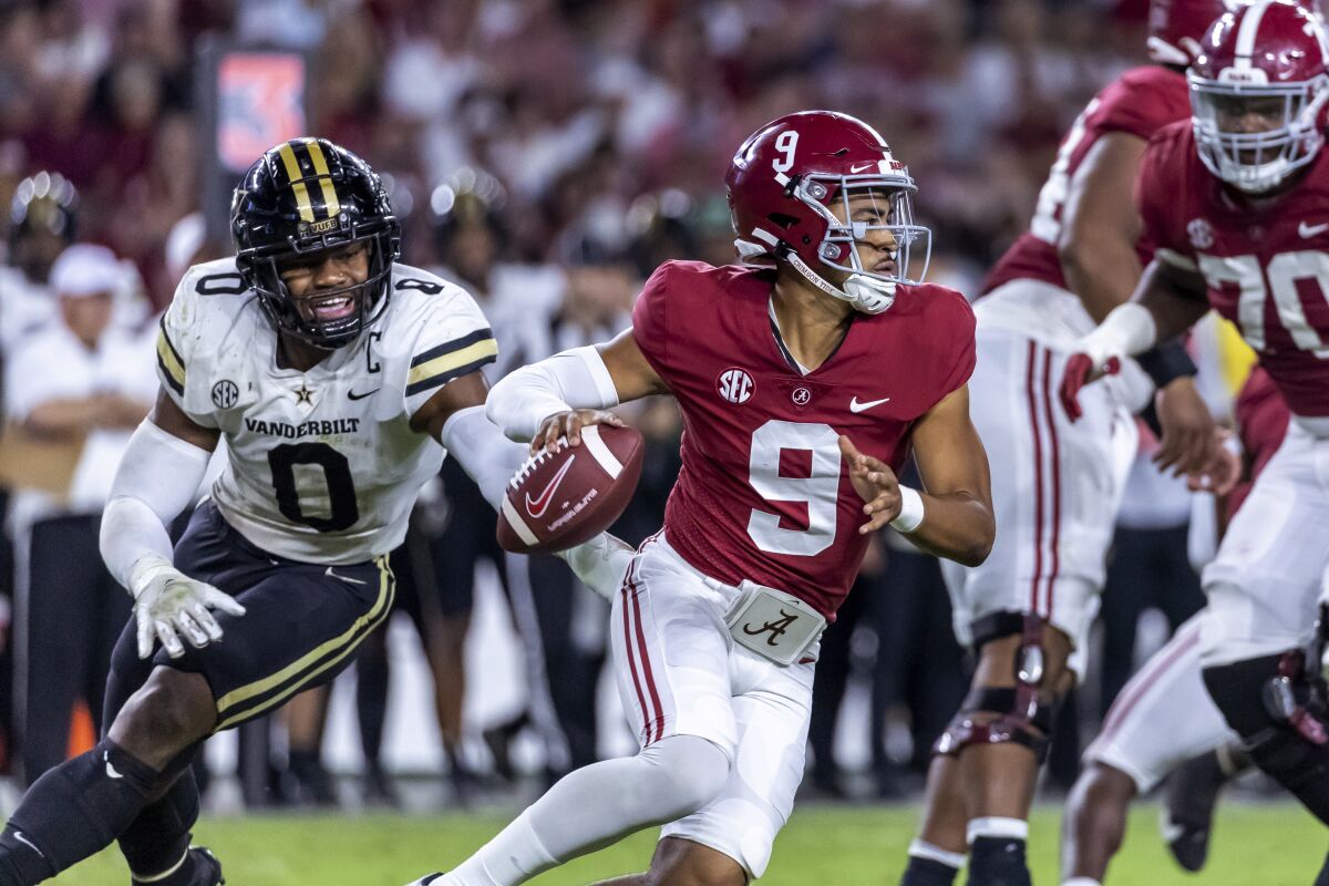 Alabama quarterback Bryce Young (9) works away from pressure from Vanderbilt linebacker Anfernee Orji (0) during the second half of an NCAA college football game Saturday, Sept. 24, 2022, in Tuscaloosa, Ala. (AP Photo/Vasha Hunt)
