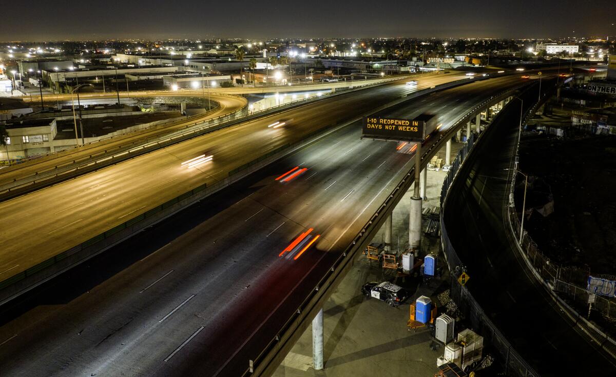 A night view of a freeway with lights from vehicles.