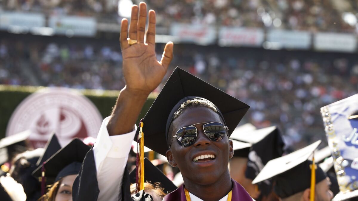 Then-Galaxy star Gyasi Zardes waves to his family while graduating from Cal State Dominguez Hills on May 19, 2017, at StubHub Center.