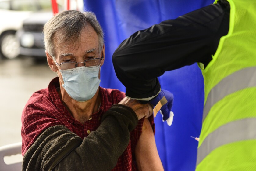 Crager Boardman, from Brattleboro, Vt., receives a shot at a flu vaccine clinic in Brattleboro on Tuesday, Oct. 26, 2021.
