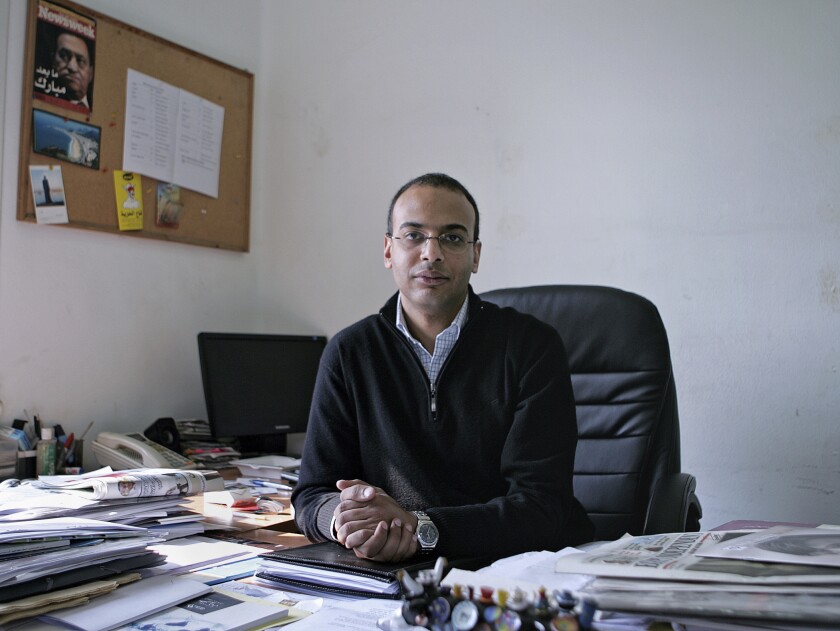 FILE -- In this Dec. 7, 2011 file photo, Hossam Bahgat sits for a photograph, in his office at the Egyptian Initiative for Personal Rights in Cairo, Egypt. On Sunday, July 18, 2021, Egypt released two activists and a journalist after they spent months in pre-trial detention. The releases came amid an outcry by rights advocates after prosecutors last week referred Hossam Bahgat, a leading Egyptian investigative journalist and human rights advocate, to trial over accusations of insulting the election authority, spreading false news alleging electoral fraud; and using social media to commit crimes, Bahgat said. (Sarah Rafea via AP, File)