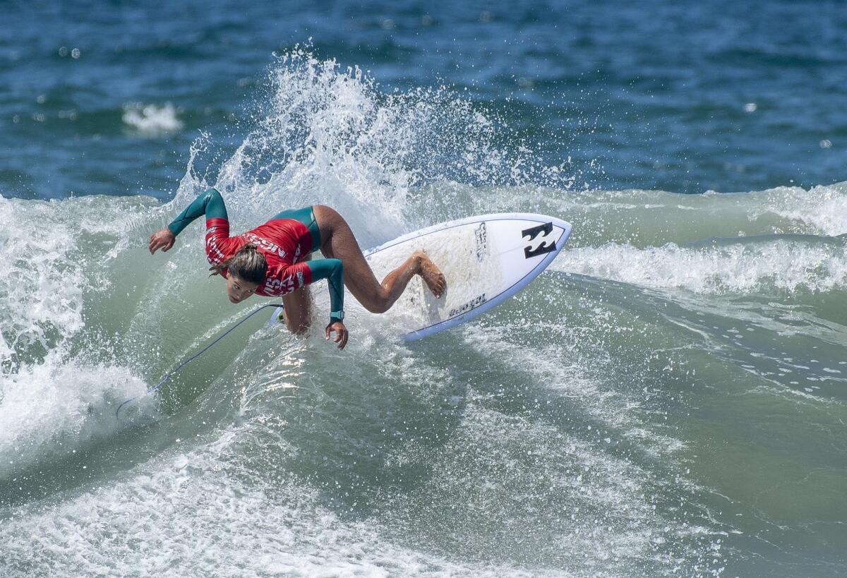 Luana Silva of Hawaii rides a wave in the women's open semifinals of the National Scholastic Surfing Assn. National Championships on Tuesday in Huntington Beach.