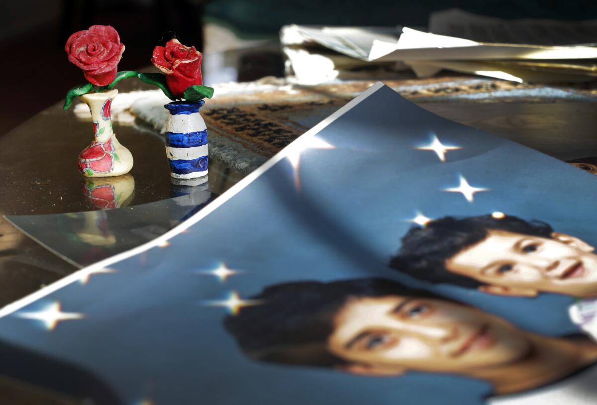 In this Dec. 10, 2014, file photo, prison artwork created by Adnan Syed sits near family photos in the home of his mother, Shamim Syed, in Baltimore. Syed, the subject of the popular podcast "Serial" will be allowed to appeal his murder conviction, a Maryland court has ruled.