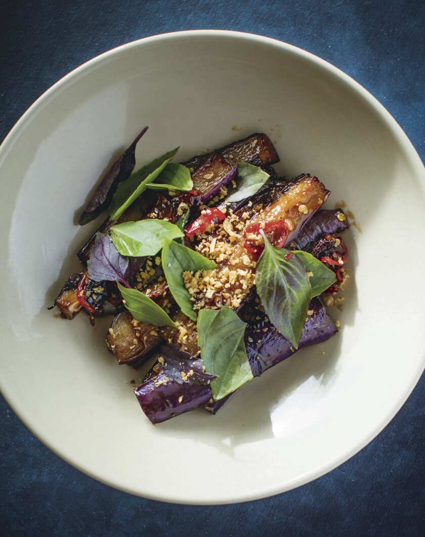 Closeup of a bowl with cooked slices of eggplant.