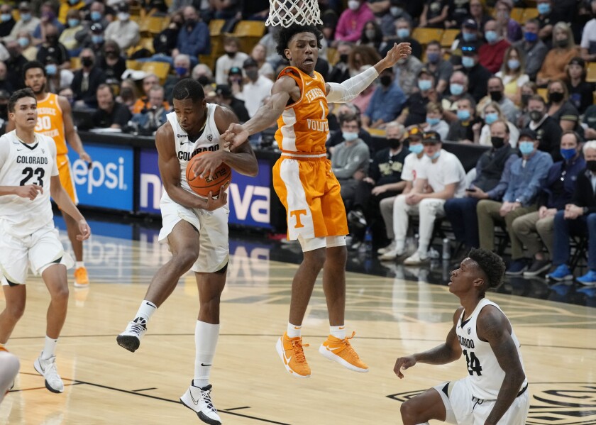Colorado guard Keeshawn Barthelemy, left, pulls down a rebound as Tennessee guard Kennedy Chandler defends in the first half of an NCAA college basketball game Saturday, Dec. 4, 2021, in Boulder, Colo. (AP Photo/David Zalubowski)