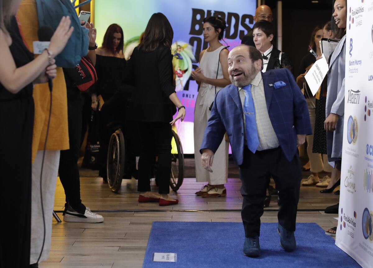 Actor and disability activist Danny Woodburn walks the “blue carpet” for the Reelabilities Film Festival at Universal Cinema.