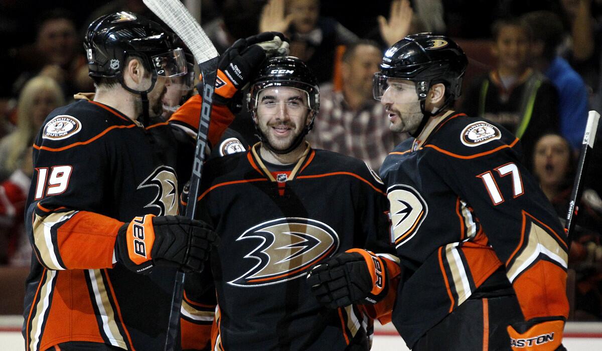 Ducks left wing Patrick Maroon (19) celebrates with center Ryan Kesler (17) and right wing Kyle Palmieri after scoring a goal against the Coyotes in the second period Sunday in Anaheim.