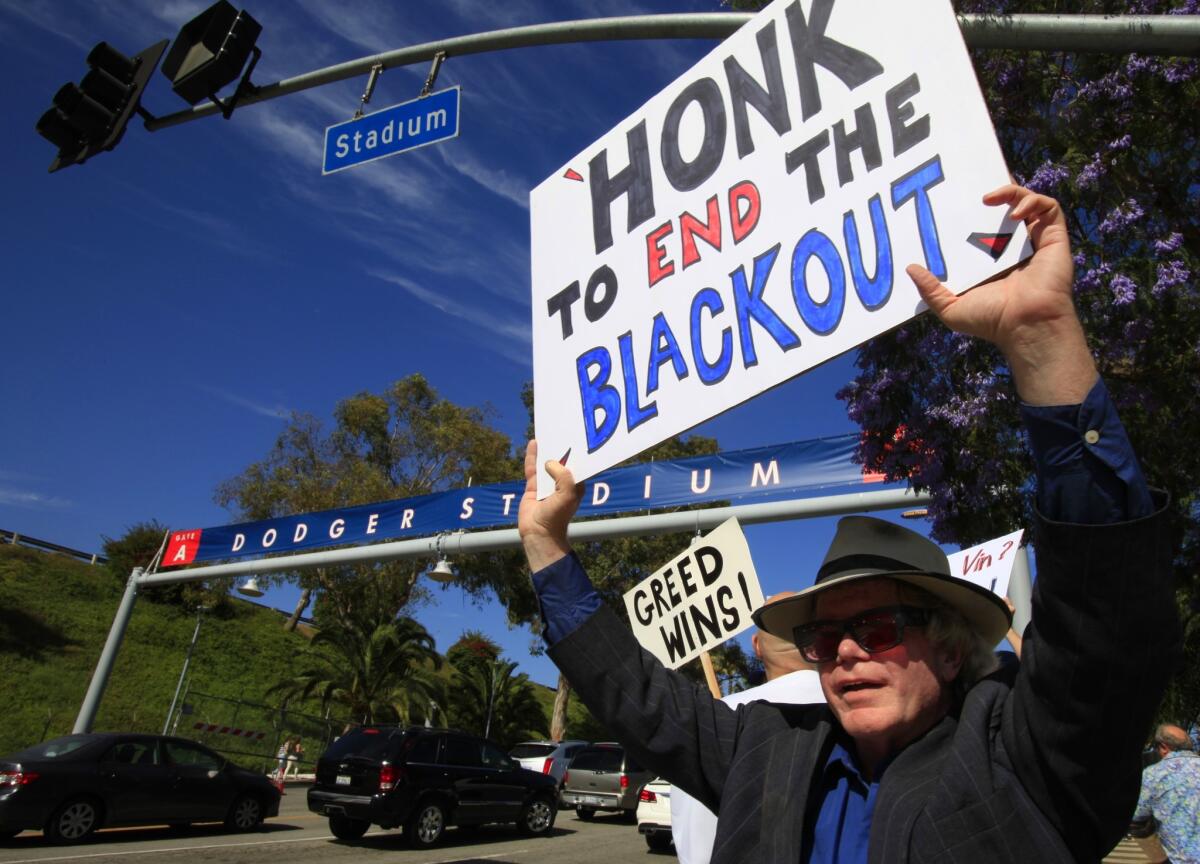 Bill Peterson of Los Angeles, along with about 25 others who were unhappy about Time Warner Cable's TV deal with the Dodgers, stage a protest outside of Dodger Stadium on June 1.