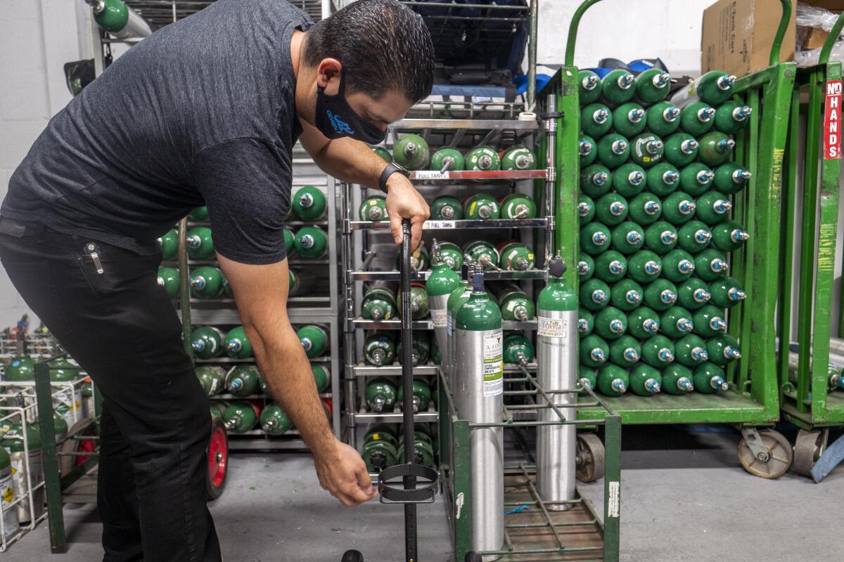 Edmond Manukyan moves oxygen cylinders at A-1 Oxygen Inc.