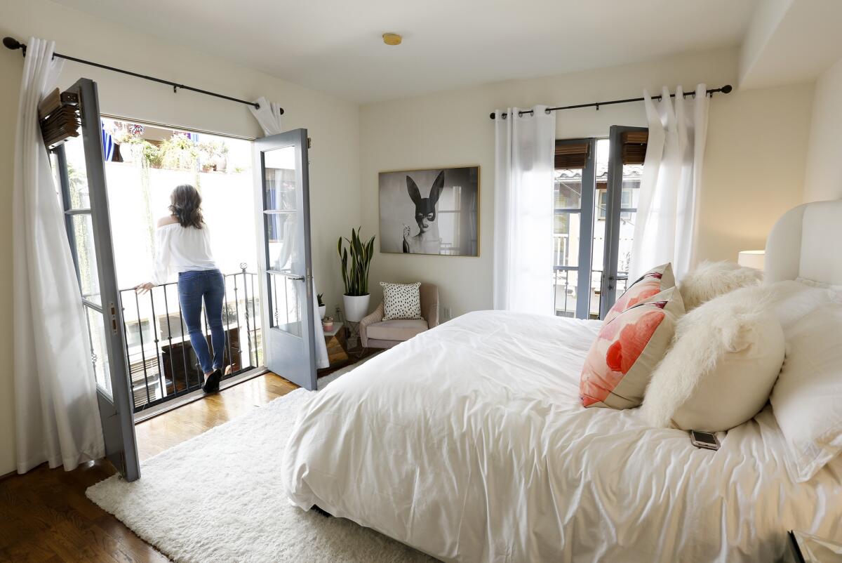 KTLA News anchor Megan Henderson stands on the Juliet balcony in her master bedroom.