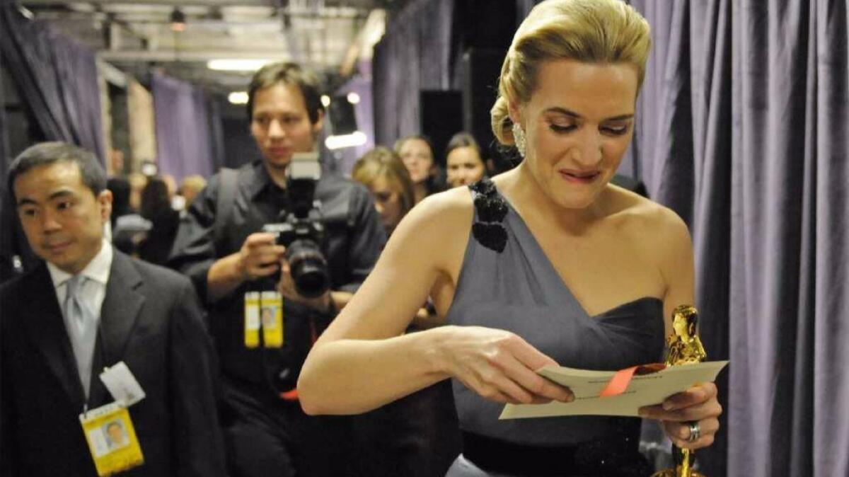 Kate Winslet walks backstage after winning the Oscar for "The Reader" in 2009.