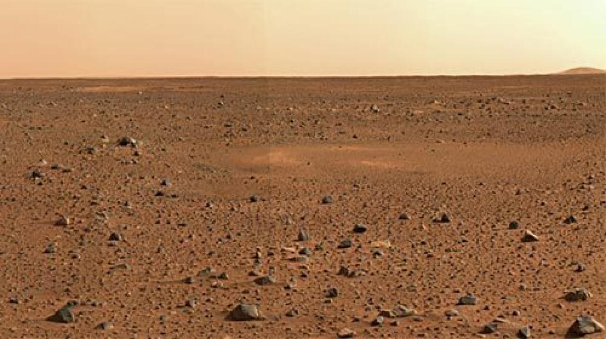 RED PLANET LANDSCAPE: An image taken by the Spirit rover shows the rocky surface of Mars and the Gusev Crater.
