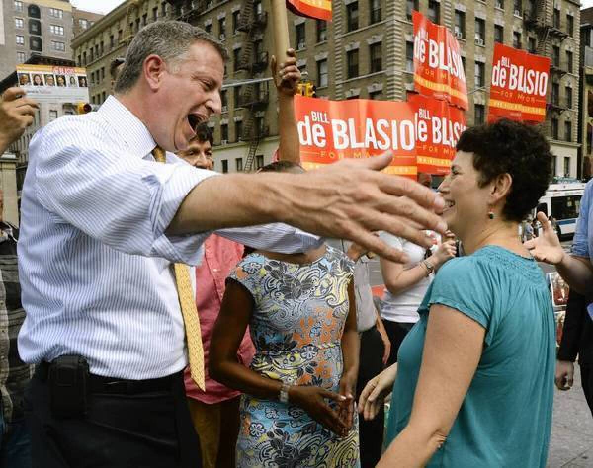 Bill de Blasio greets voters in Manhattan during the primary vote to choose New York's Democratic candidate for mayor.