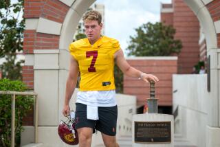 LOS ANGELES, CA - AUG. 5, 2022: USC quarterback Miller Moss taps a sword.