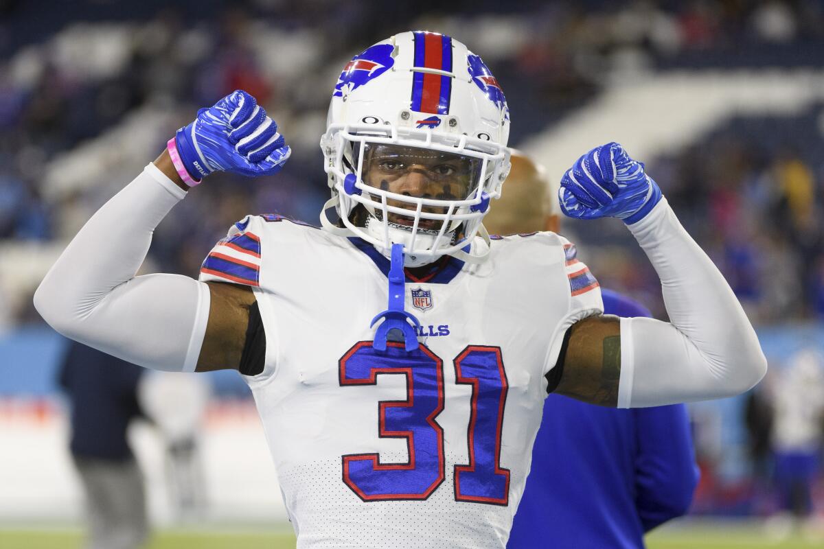 Buffalo Bills safety Damar Hamlin flexes before a game in 2021.