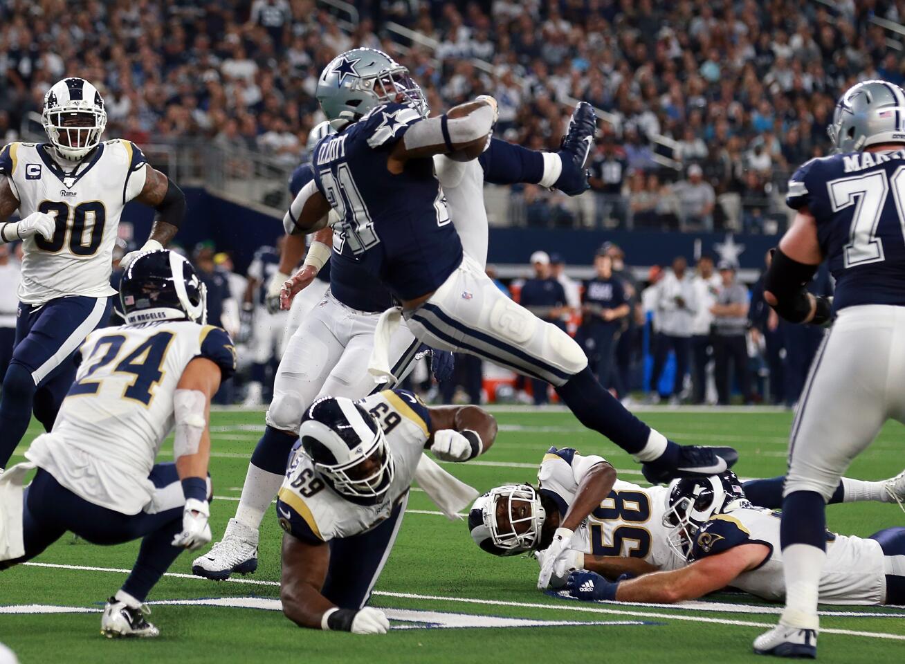 Dallas Cowboys running back Ezekiel Elliott goes airborne after being hit by Rams defenisve tackle Sebastian Joseph-Day.