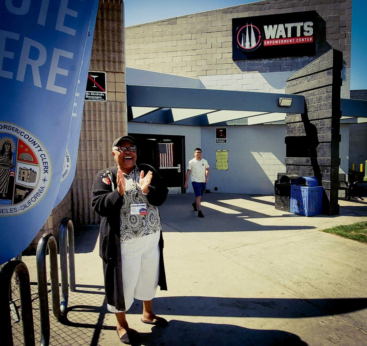 Volunteer Bobbie Thompson cheers voters at the polling station in the Imperial Courts public housing complex in Watts.